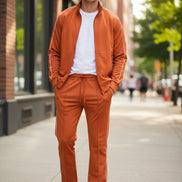 Orange tracksuit with white piping on a  outside