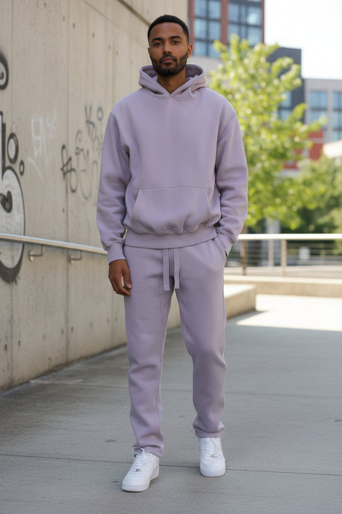 Person wearing a light purple tracksuit  outside