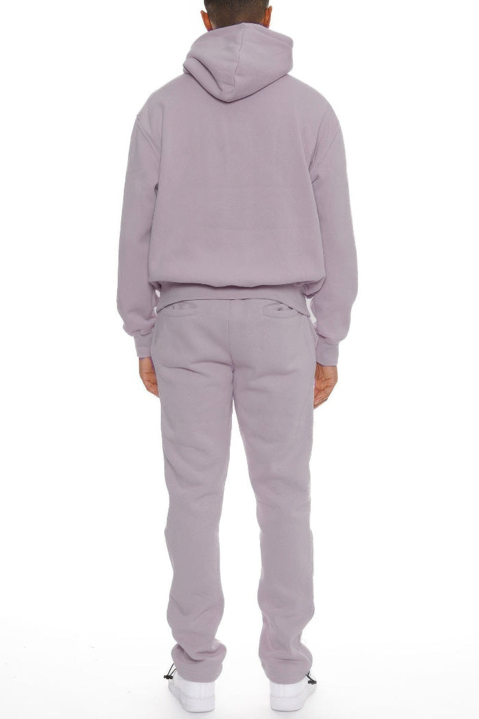 Person wearing a light gray tracksuit on  outside