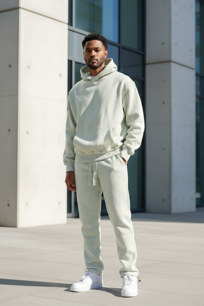 Person wearing a beige hoodie and pants set on a  outside