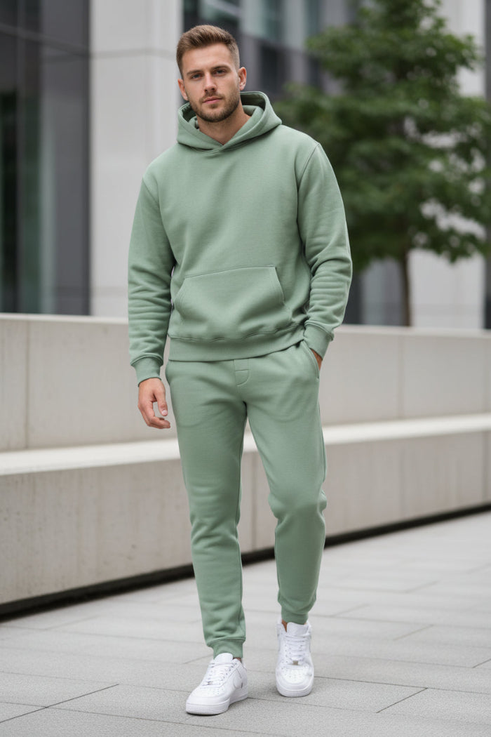 Person wearing a green tracksuit outside