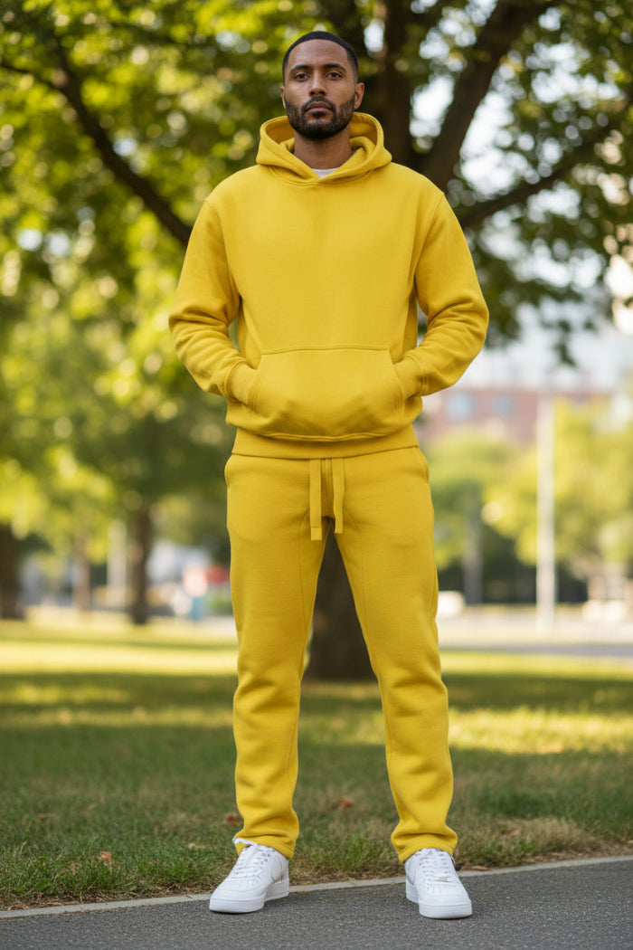 Person wearing a yellow tracksuit on a white background