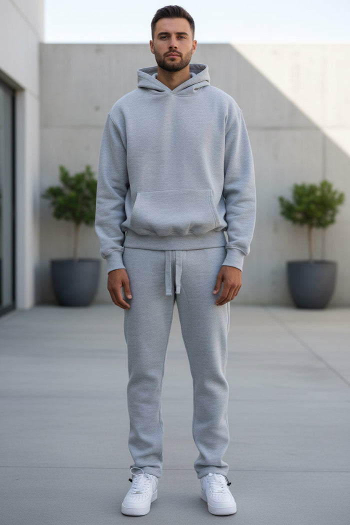 Person wearing a gray tracksuit outside