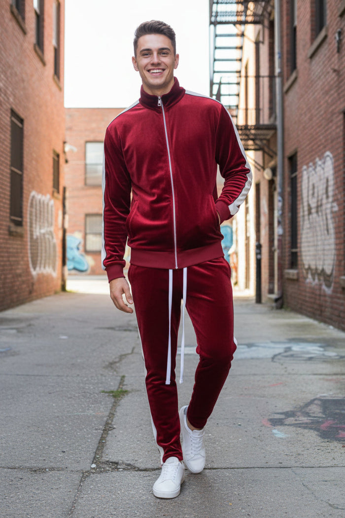 Man wearing a red tracksuit with white stripes  outside