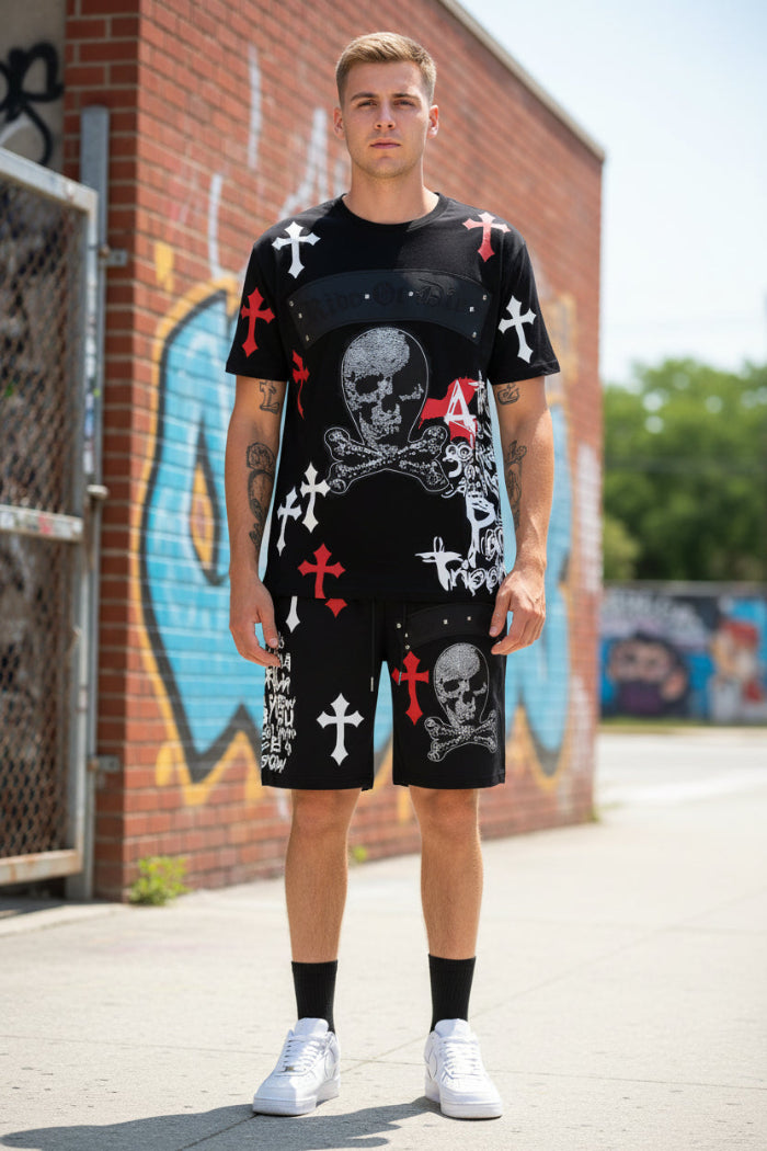 Person wearing a black outfit with skull and crossbones design  outside