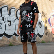 Man wearing a black outfit with skull and crossbones design  outside