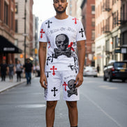 Person wearing a white t-shirt and shorts with skull and crossbones design outside