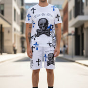 Man wearing a white t-shirt and shorts with graphic designs  outside