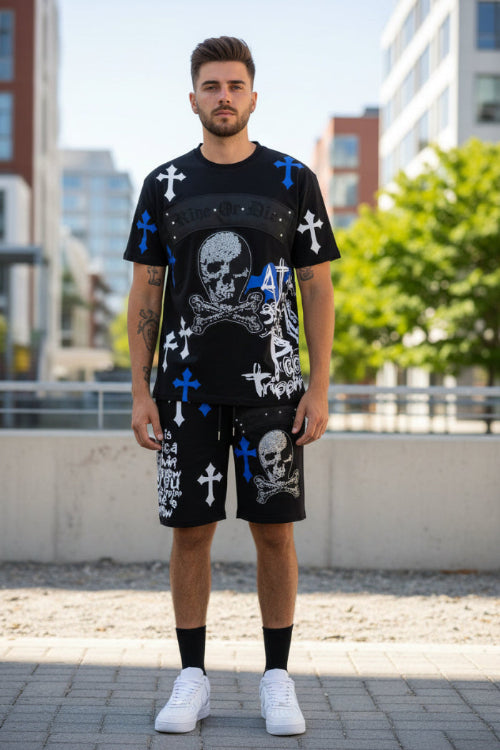 Man wearing a black outfit with skull and crossbones design  outside