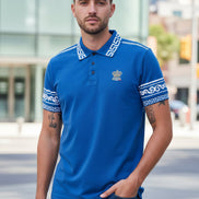 Man wearing a blue polo shirt with white patterns on a white background