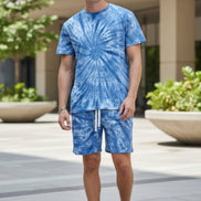 Person wearing a blue tie-dye shirt and shorts set  outside