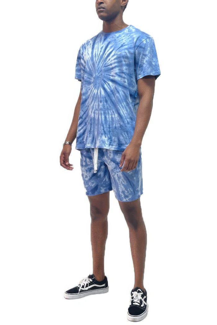 Person wearing a blue tie-dye outfit with shorts outside
