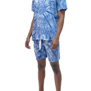 Person wearing a blue tie-dye outfit with shorts outside
