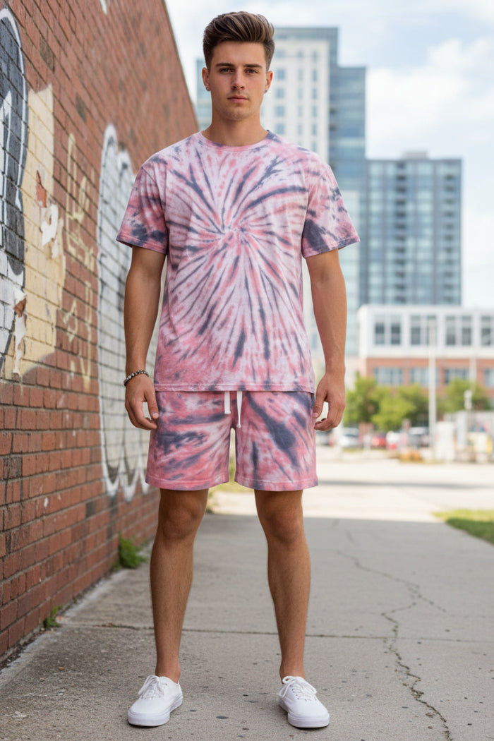 Person wearing a pink and blue tie-dye outfit outside