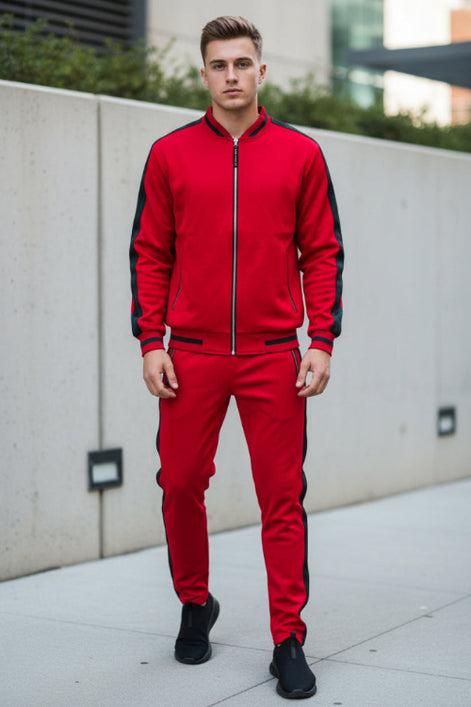 Person wearing a red tracksuit with black accents picture taken outside