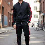 Person wearing a black and red tracksuit taken outside