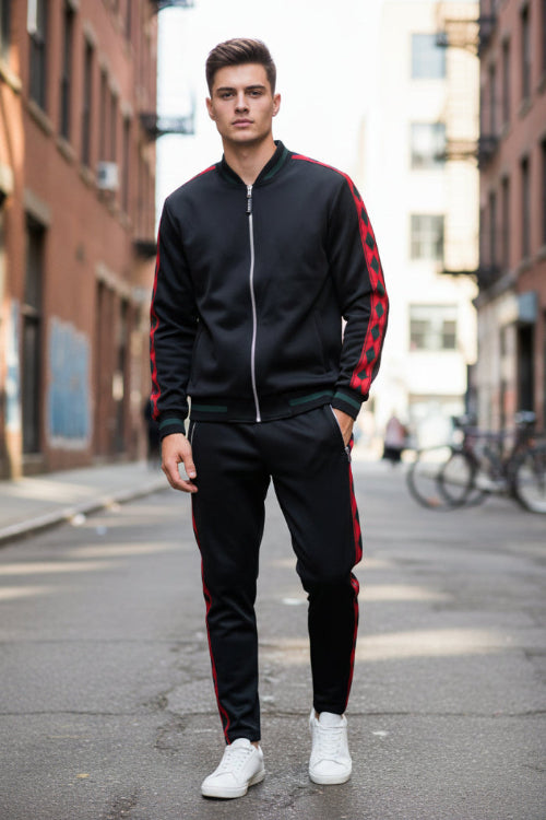 Person wearing a black and red tracksuit taken outside