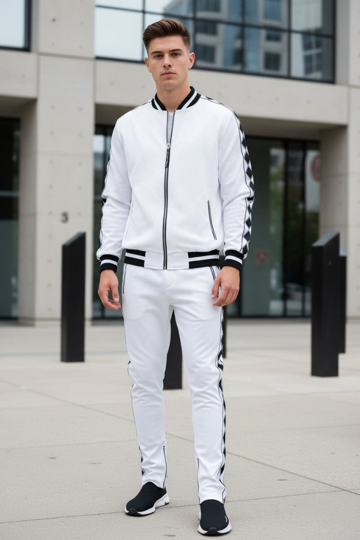 Man wearing a white tracksuit with black stripes taken outside