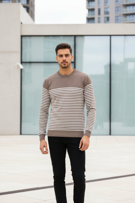 Man wearing a brown and beige striped sweater on a white background