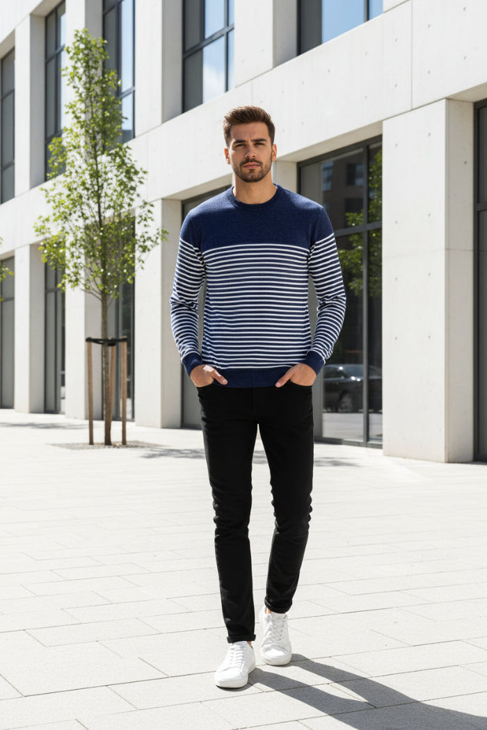 Man wearing a navy and white striped sweater on a white background