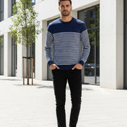 Man wearing a navy and white striped sweater on a white background