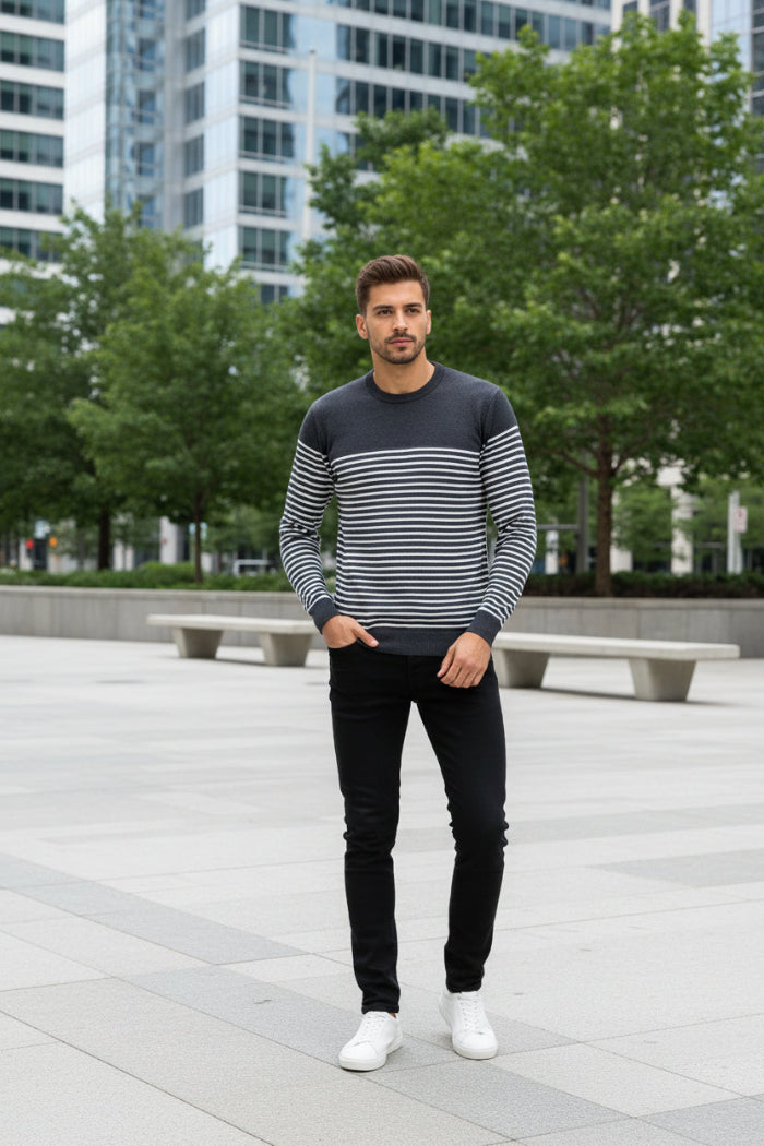 Man wearing a black and white striped sweater on a white background
