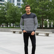 Man wearing a black and white striped sweater on a white background
