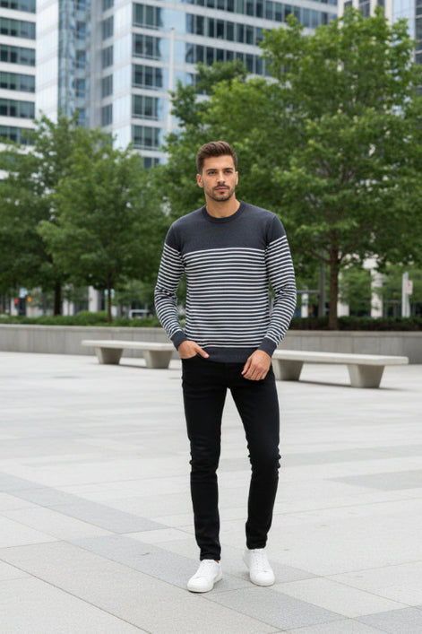 Man wearing a black and white striped sweater on a white background