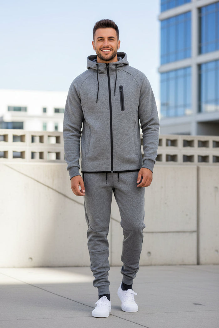 Man wearing a gray tracksuit taken outside