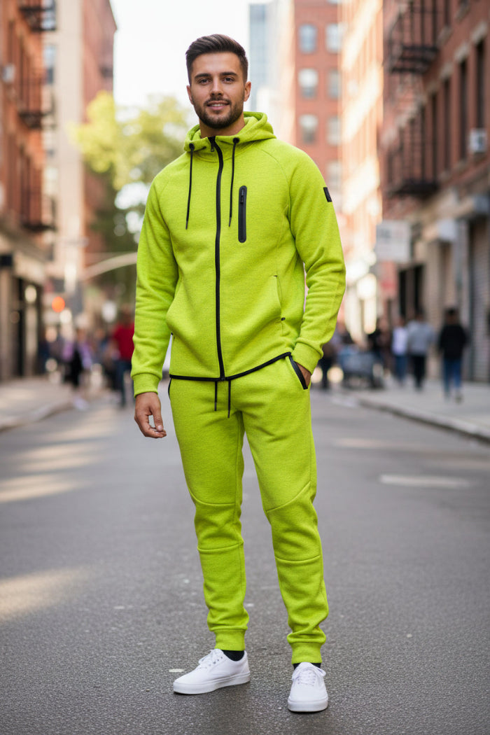 Person wearing a bright yellow tracksuit with black accents taken outside