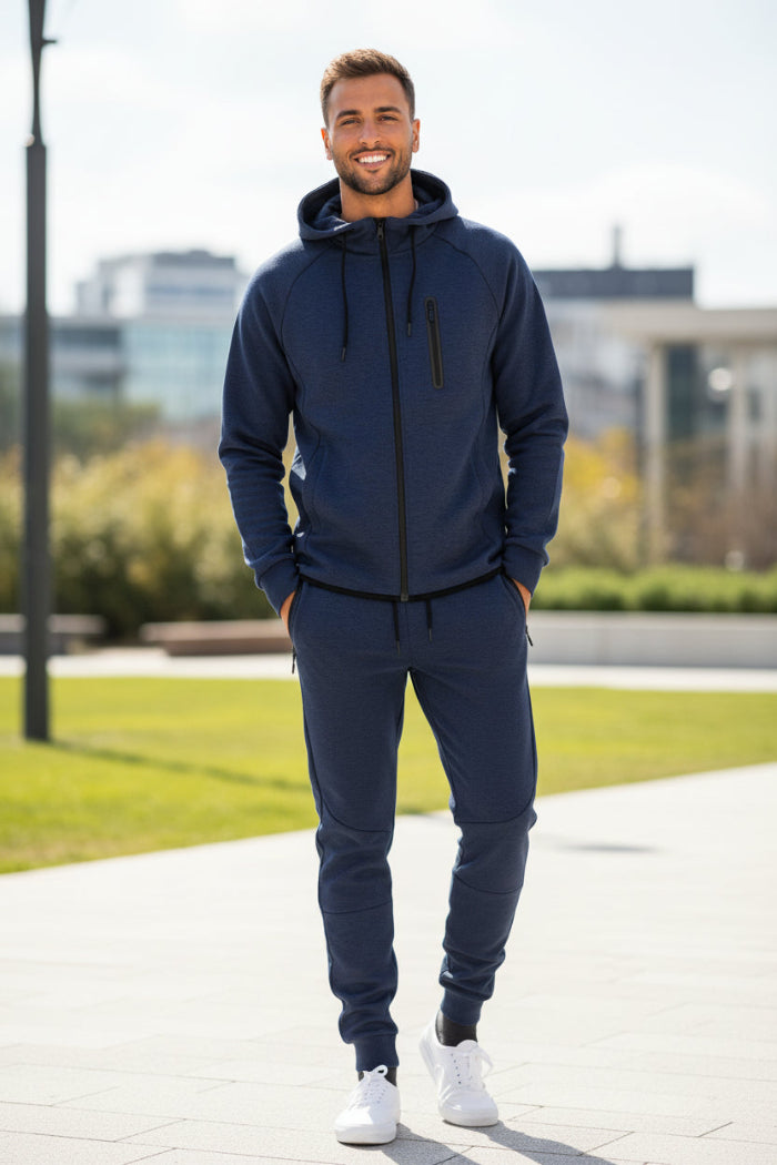 Man wearing a navy blue tracksuit taken outside
