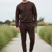 Man wearing a purple tracksuit taken outside