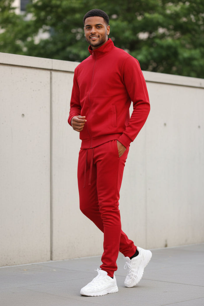 Man wearing a red tracksuit taken outside