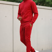 Man wearing a red tracksuit taken outside