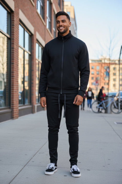 Man wearing a black tracksuit taken outside
