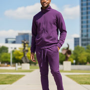 Man wearing a purple tracksuit  taken outide