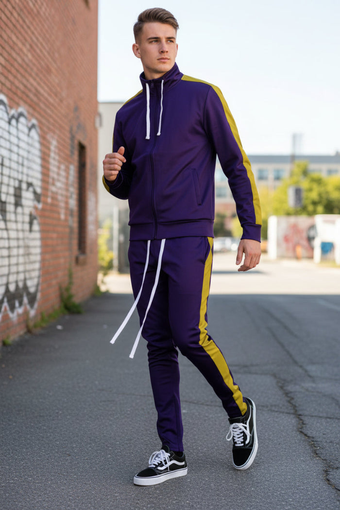 Person wearing a purple tracksuit with yellow stripes taken outside