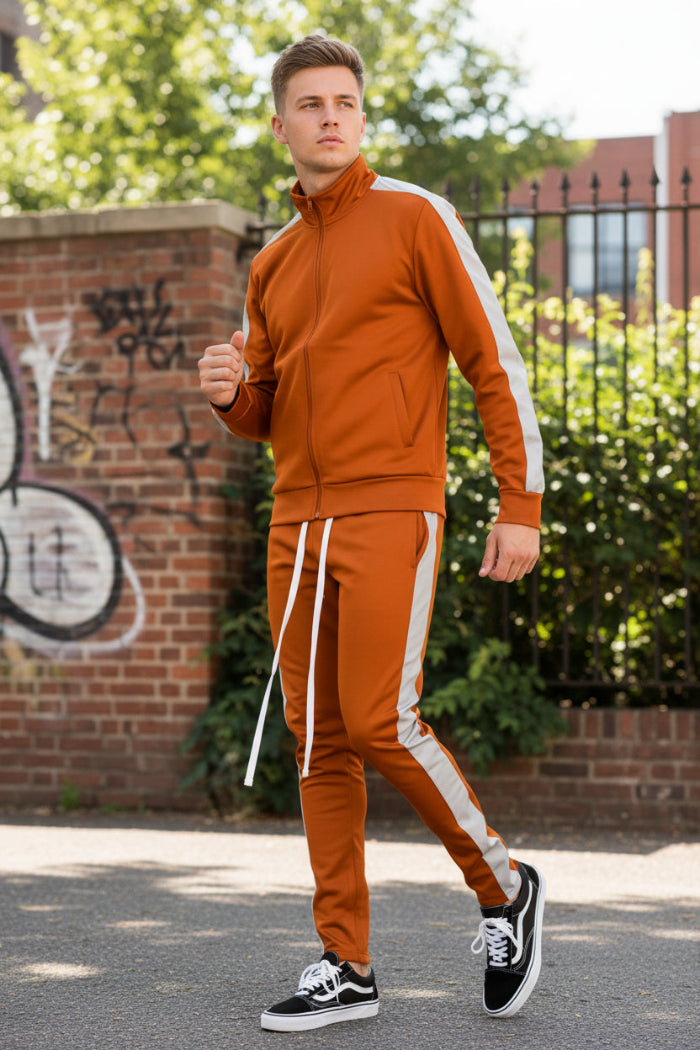 Person wearing an orange tracksuit with white stripes  taken outsie