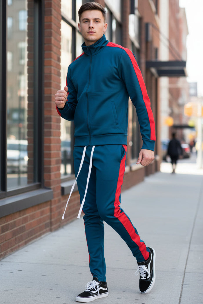 Man wearing a blue tracksuit with red stripes taken outside
