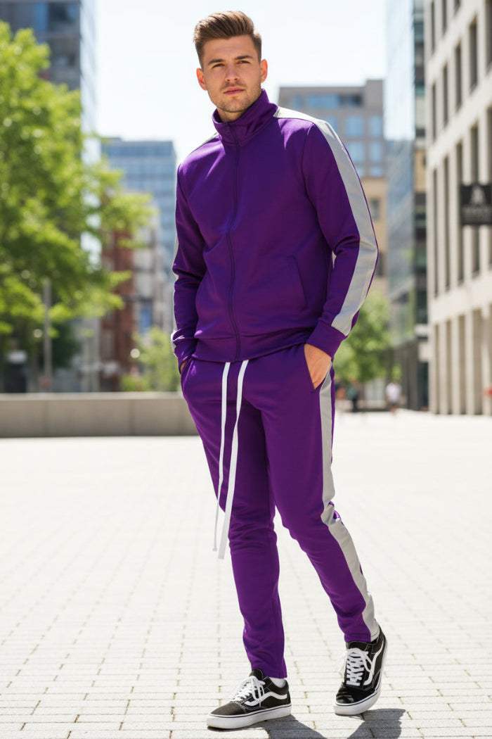 Person wearing a purple tracksuit with white stripes  taken outside