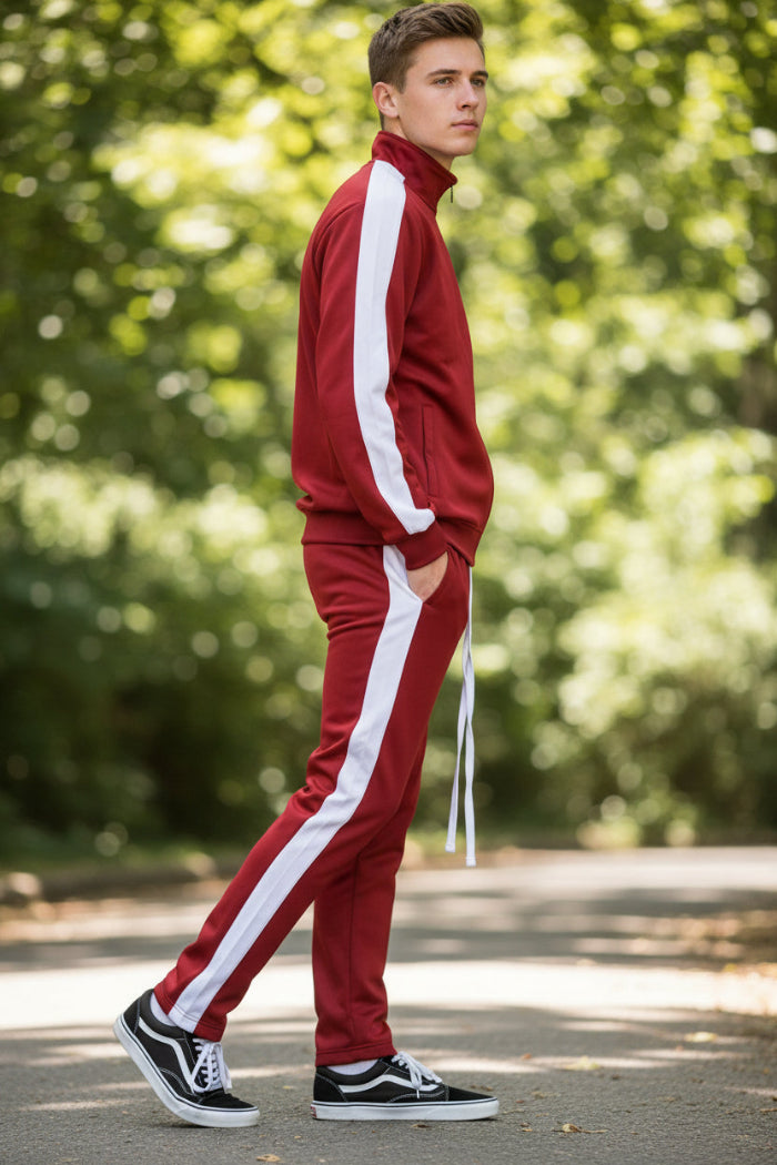 Person wearing a red tracksuit with white stripes  taken outside