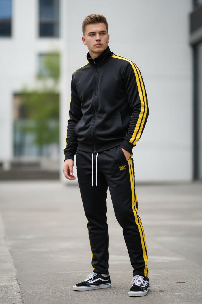 Person wearing a black and yellow tracksuit  taken outside
