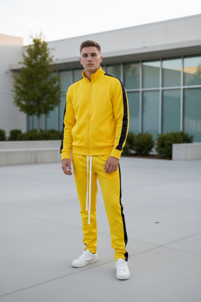 Yellow tracksuit with black stripes worn by a person taken outside