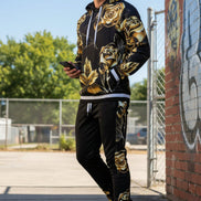 Man wearing a black and gold floral tracksuit  taken outside