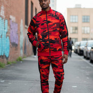Man wearing a red and black camouflage tracksuit  taken outside
