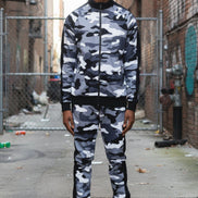 Person wearing a camouflage tracksuit  taken outside