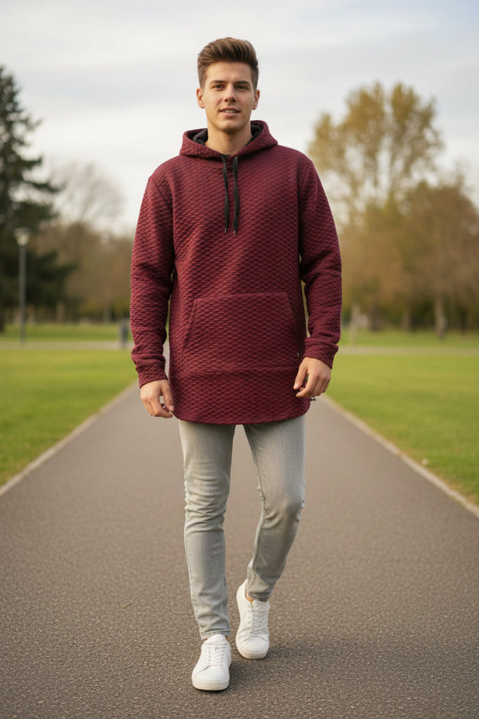 Maroon textured hoodie worn by a person on a white background
