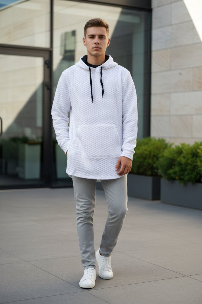 Person wearing a textured white hoodie with black drawstrings on a white background