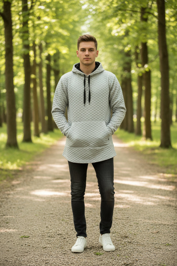 Person wearing a textured gray hoodie with a white background