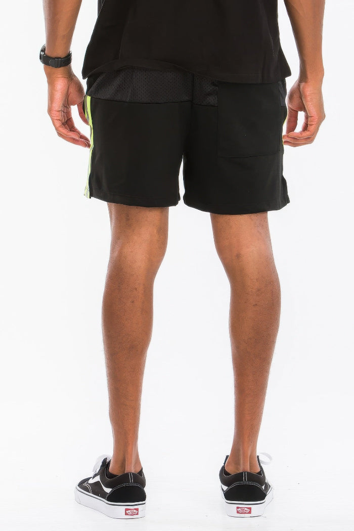 Person wearing black shorts on a white background